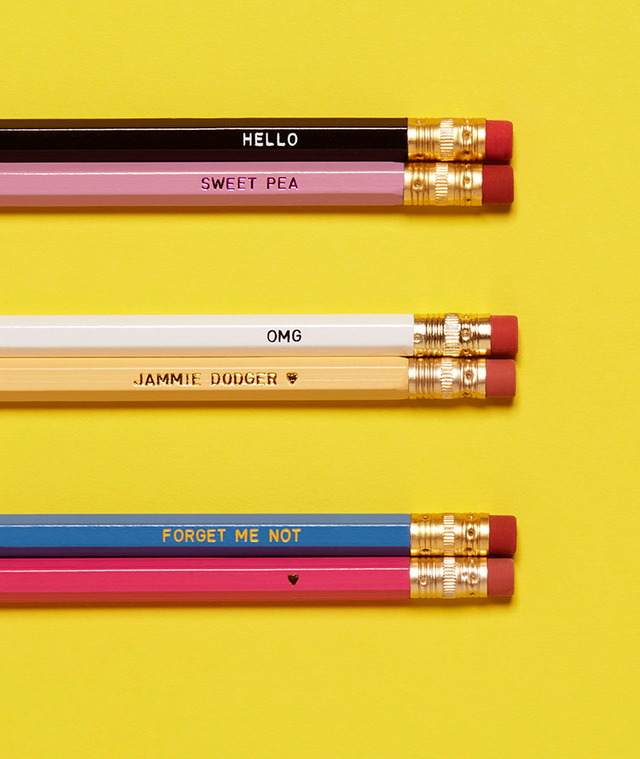 cropped coloured pencils with erasers at the top against a yellow background